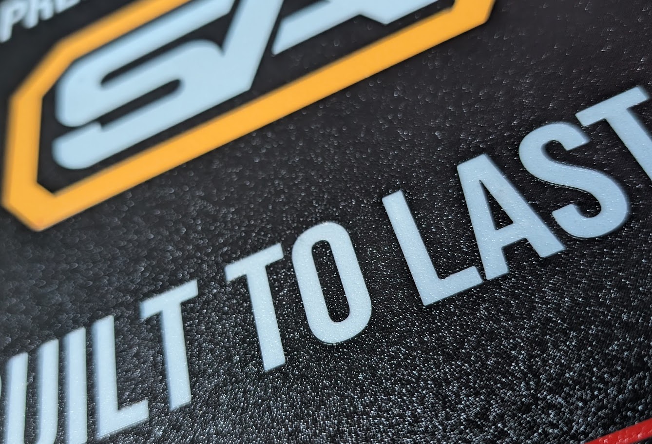 Close-up detail of premium matte finish and integrated multi-color text on SignAptics sign