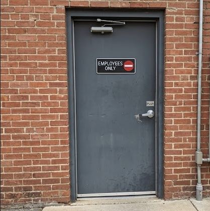 Employees Only sign mounted on an exterior commercial door